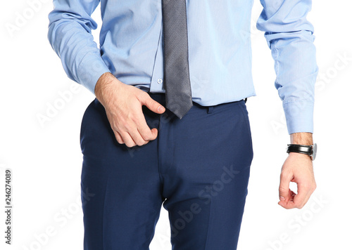 Man scratching crotch on white background, closeup. Annoying itch