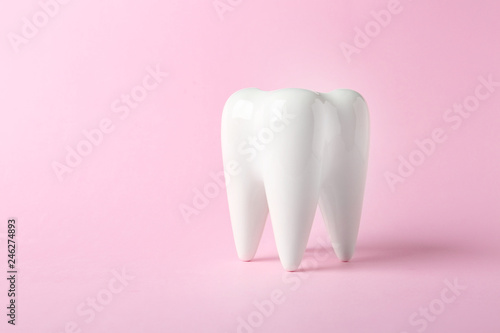 Fototapeta Naklejka Na Ścianę i Meble -  Ceramic model of tooth on color background. Space for text