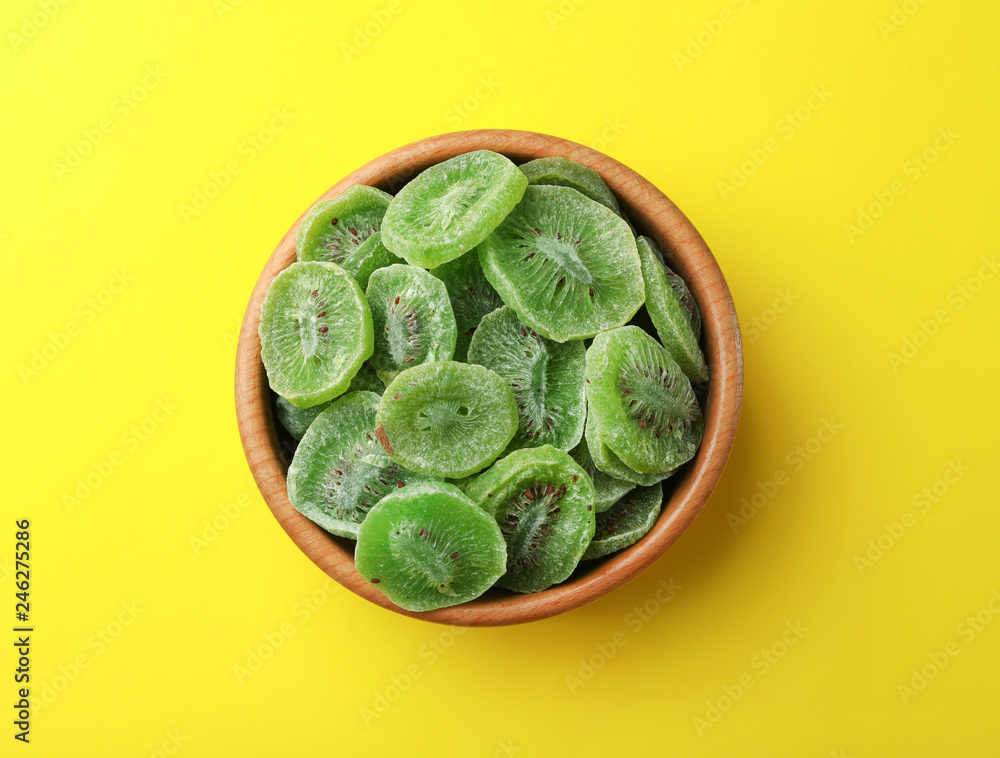 Bowl with slices of kiwi on color background, top view. Dried fruit as healthy food Bowl with slices of kiwi on color background, top view. Dried fruit as healthy food