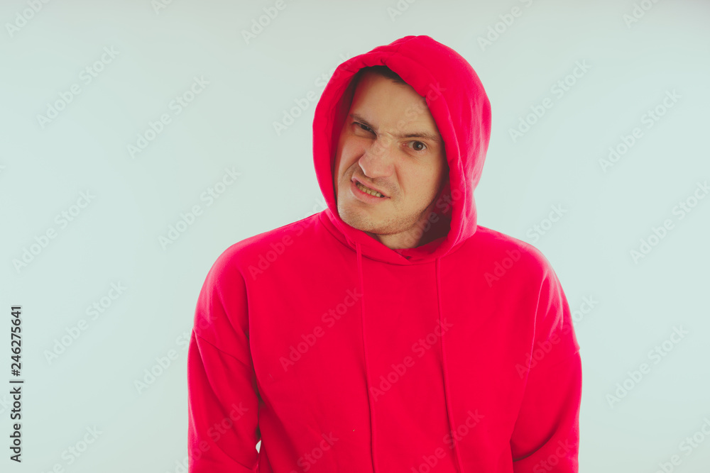 Crazy and charismatic guy posing. A man in a red tracksuit. Man isolated on white background, space for text