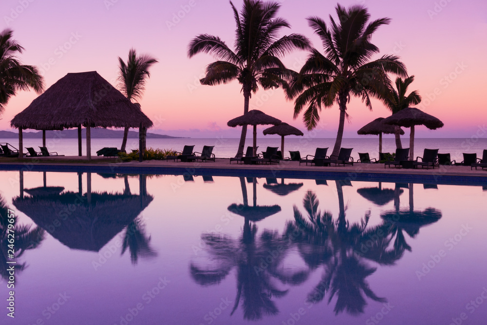 Pinkish purple sunrise colors reflecting in the water in Fiji