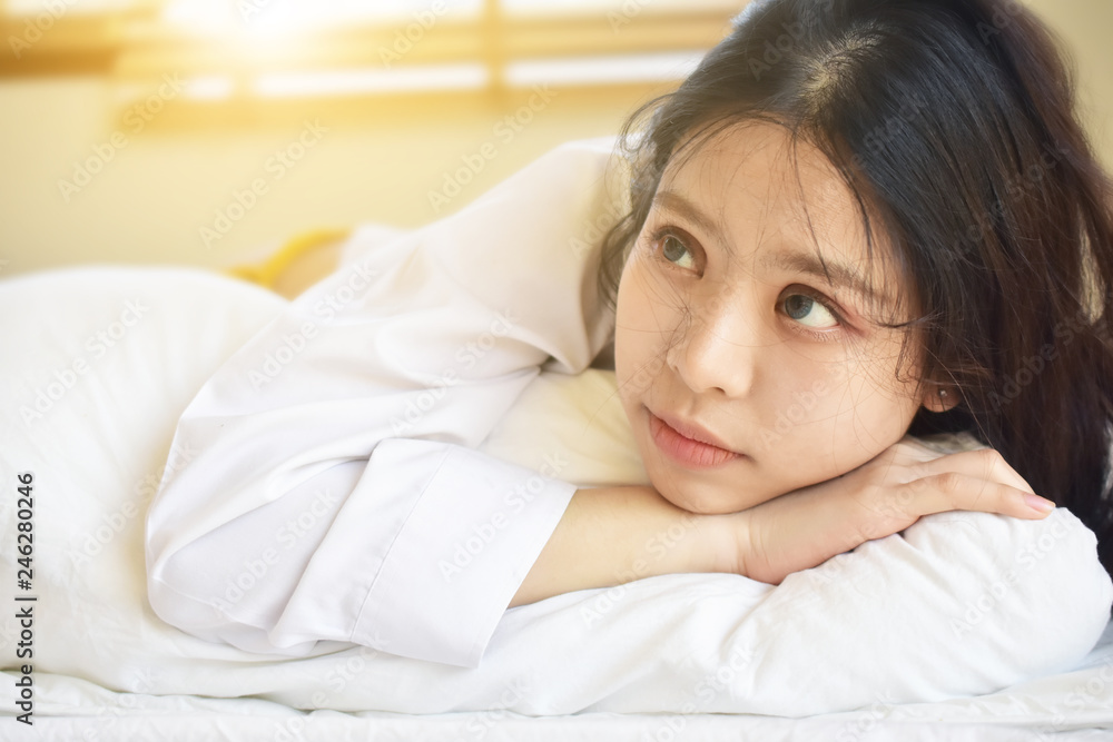 Beautiful women are waking up and on a white bed in the morning. Beautiful women are waking up and on a white bed in the morning.