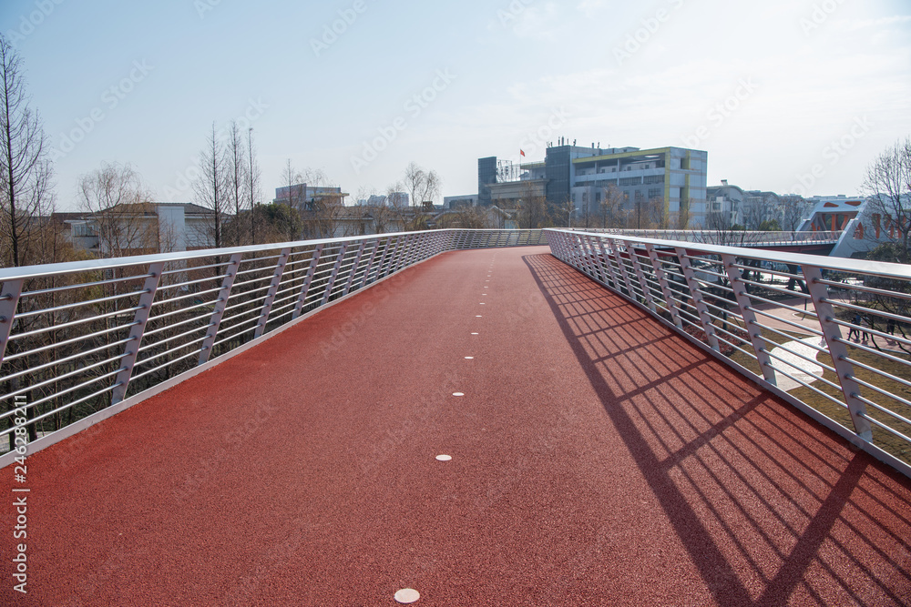 Rubber track under modern steel bridge Rubber track under modern steel bridge