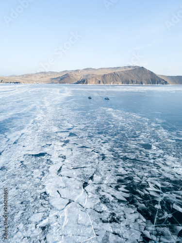 Aerial view of the frozen Lake Baikal on Olkhon island in winter from drone.