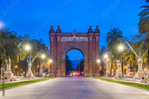 Bacelona Arc de Triomf at night in the city of Barcelona in Catalonia, Spain. The arch is built in reddish brickwork in the Neo-Mudejar style photo