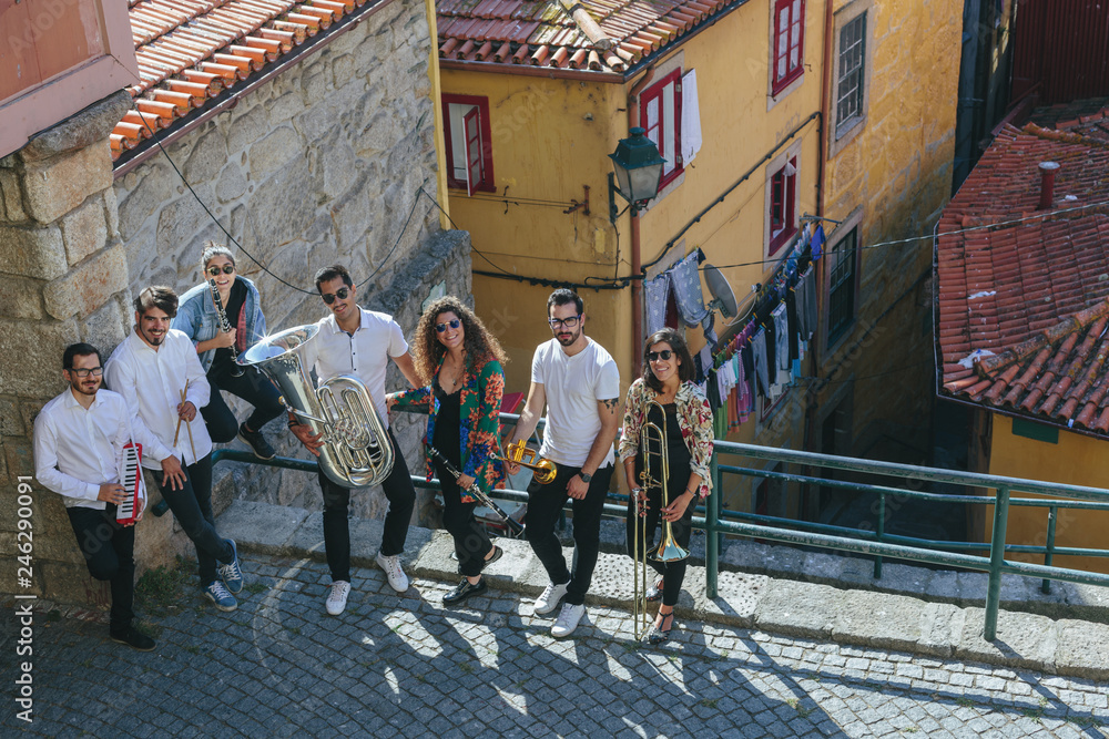 Portrait of Musician band staying together outdoor on European  city street