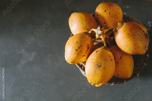 Yellow orange coconut on grey background in Sri Lanka
