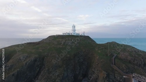 Aerial view of Strumble Head Lighthouse in the evening. Drone towards up and over. photo