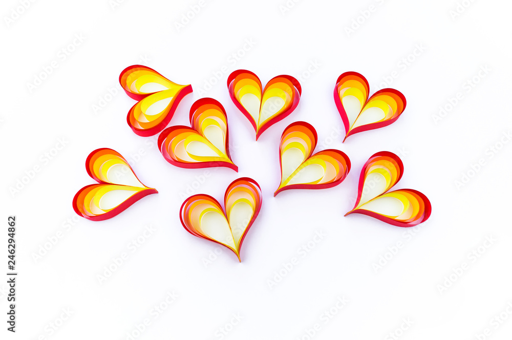 Heart made of paper of red orange and yellow color. White background.