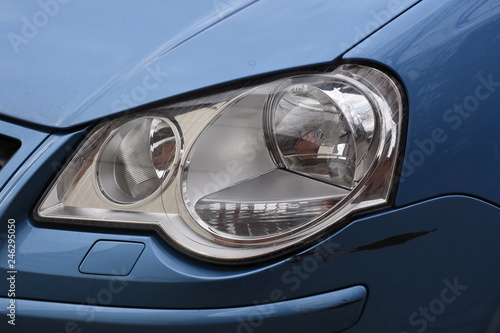 shiny headlight on a  white car © Laurenx