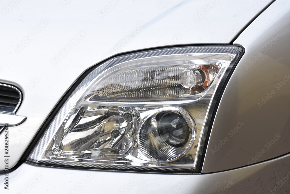 shiny headlight on a  white car
