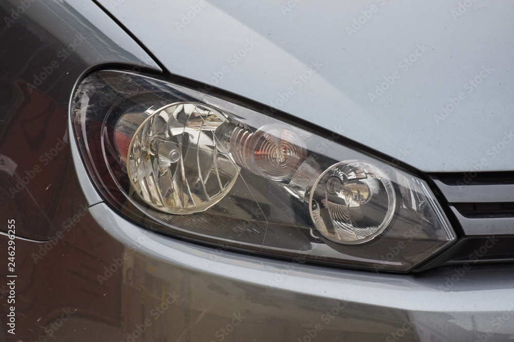 shiny headlight on a white car shiny headlight on a white car