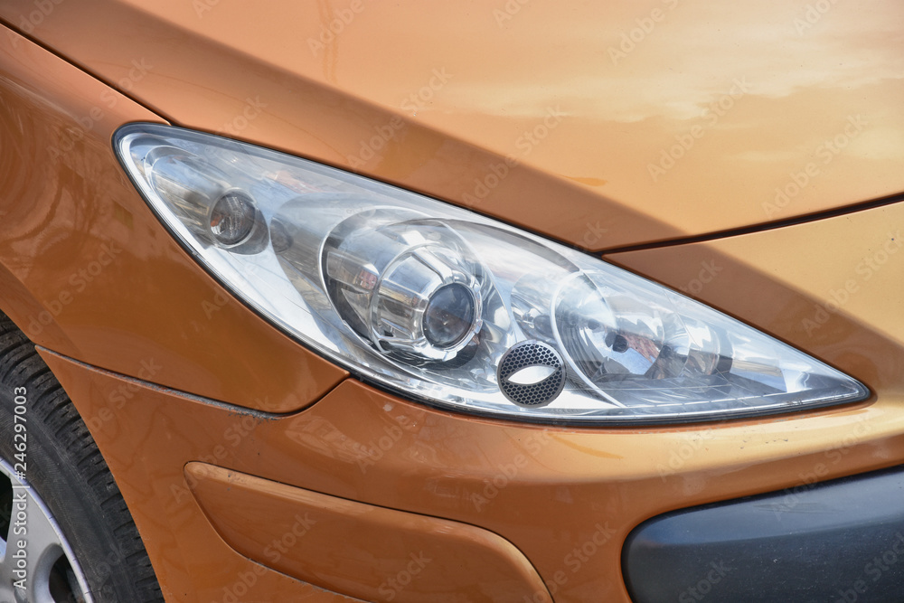  Car's exterior. shiny headlights on a brown sienna car