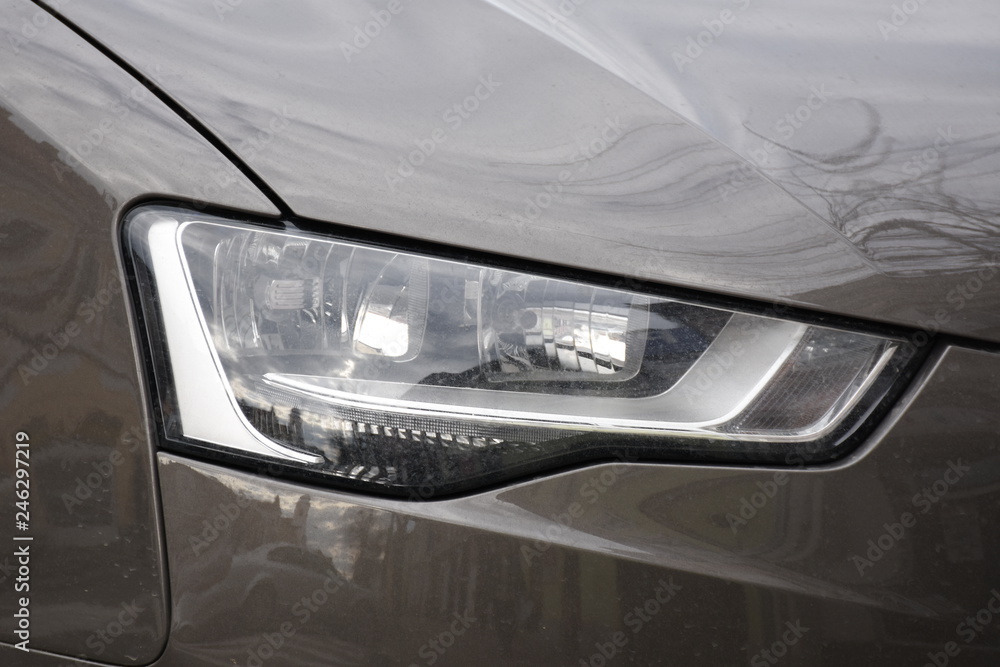  Car's exterior details. shiny headlights on a  brown car