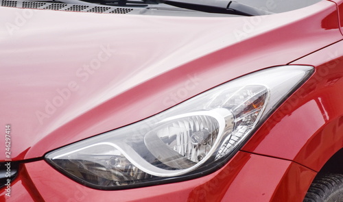  Car s exterior details. shiny headlights on a red car