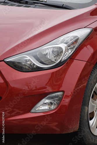  Car's exterior details. shiny headlights on a red car © Laurenx