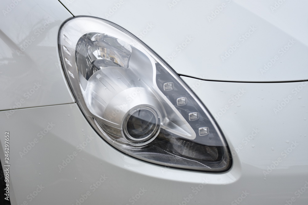 shiny headlights on a white silver car shiny headlights on a white silver car