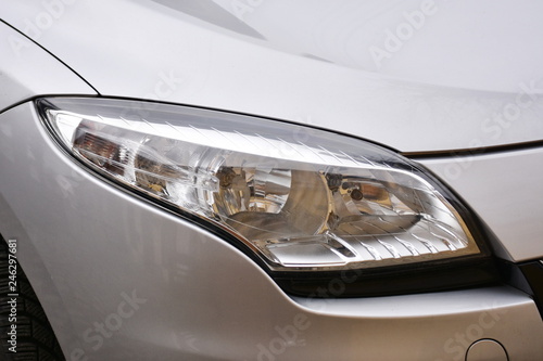 shiny headlights on a white silver car