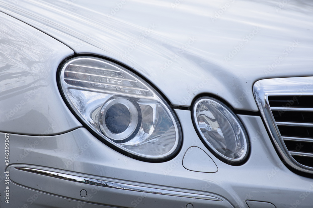 Car's exterior detail, headlight on a  silver car