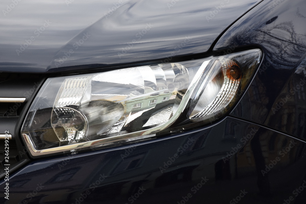 Car'sCar exterior detail.shiny headlight on a black  car exterior detail, headlight on a  new car