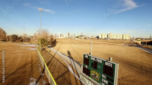 Aerial: Reveal shot of Downtown Denver, Colorado from a baseball scoreboard photo