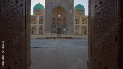 A view of grand islamic school from behind great gate in Bukhara, Uzbekistan. photo