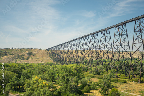railway bridge crossing a river to the horizon