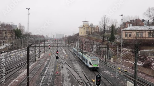 train slowly moving on rail tracks in a cityscape in winter photo