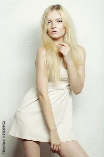 young fashion blond woman in white dress posing in studio © Raisa Kanareva