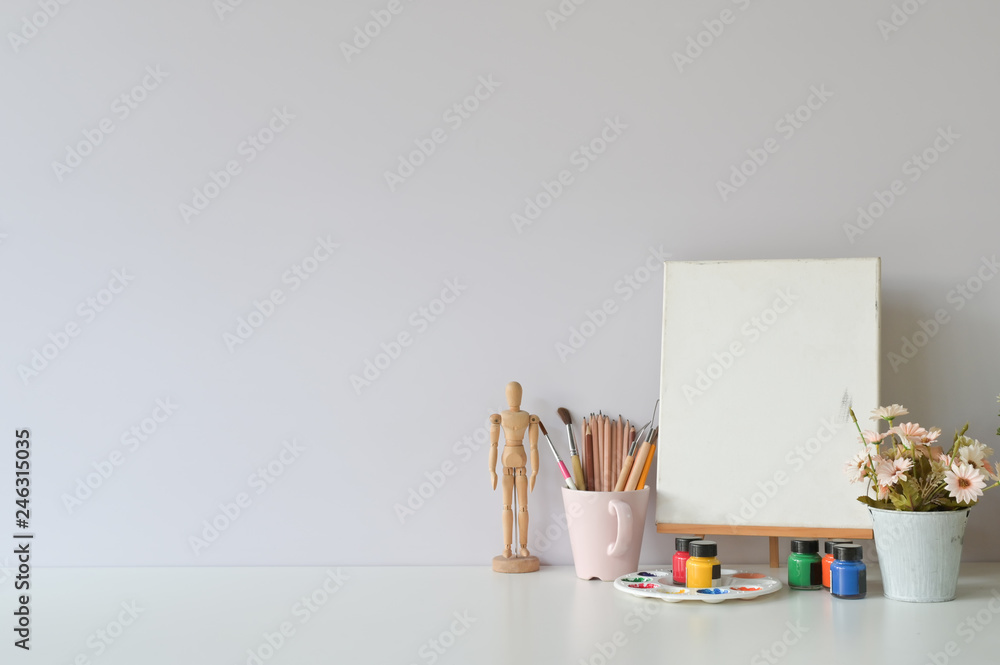 Obraz premium Office creative table with supplies and white wall.