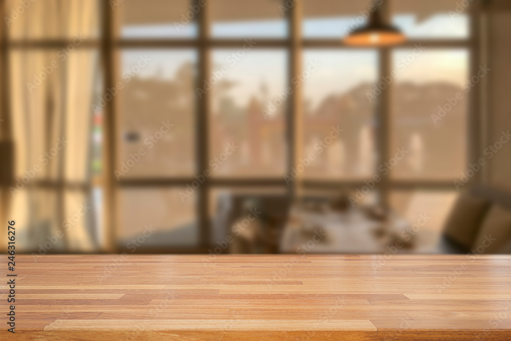 Empty wooden table and blurred modern  kitchen coffee cafe background with windows, restaurants. Ready for product montage, bokeh , warm light