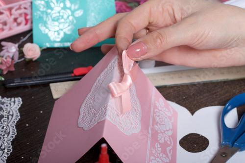 Making greeting cards from paper, cardboard and tape. Female artisan working with tape.