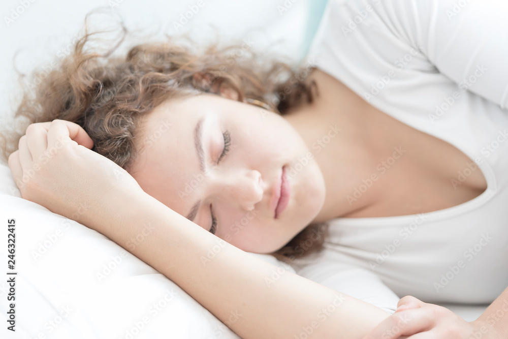 Young beautiful woman sleeping in her bed and relaxing in the morning ,she is resting with eyes closed after Insomnia a long time. Healthcare Concept Young beautiful woman sleeping in her bed and relaxing in the morning ,she is resting with eyes closed after Insomnia a long time. Healthcare Concept
