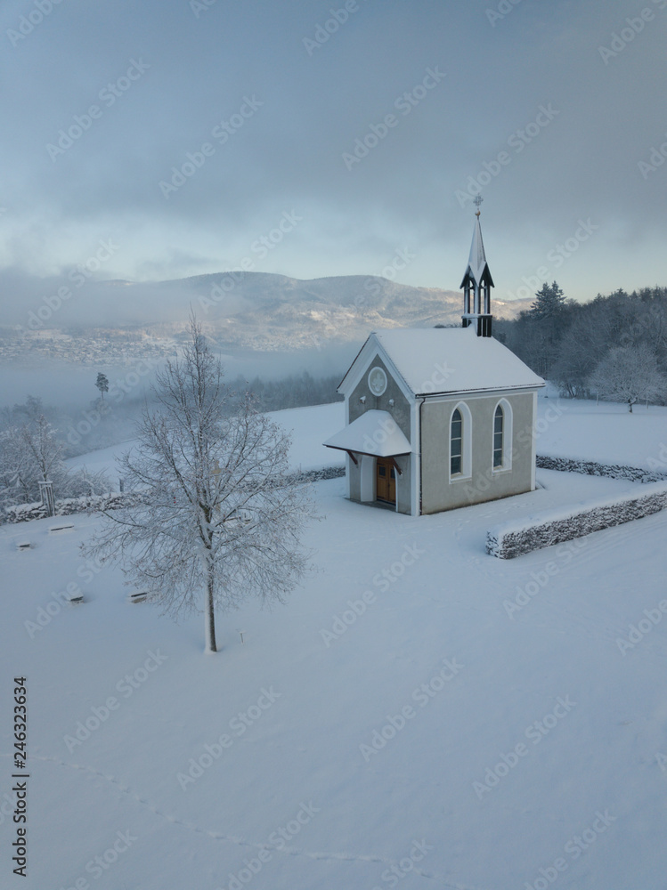Winter Switzerland fairytale chapel on hill 