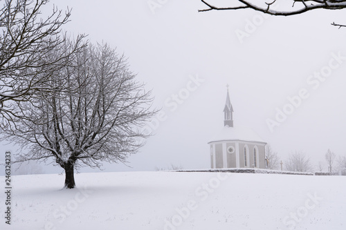 Winter Switzerland fairytale chapel on hill  photo