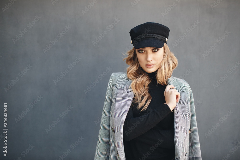 Portrait of beautiful woman with long curly blond hair outdoors in spring. Young woman with natural makeup in a gray jacket . A smart photo of a young beautiful woman in autumn clothes. Portrait of beautiful woman with long curly blond hair outdoors in spring. Young woman with natural makeup in a gray jacket . A smart photo of a young beautiful woman in autumn clothes.