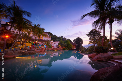 Fototapeta Naklejka Na Ścianę i Meble -  Sunset and romantic atmosphere sky on swimming pool side in Pangkor island . Beautiful travel destination for summer vacation.