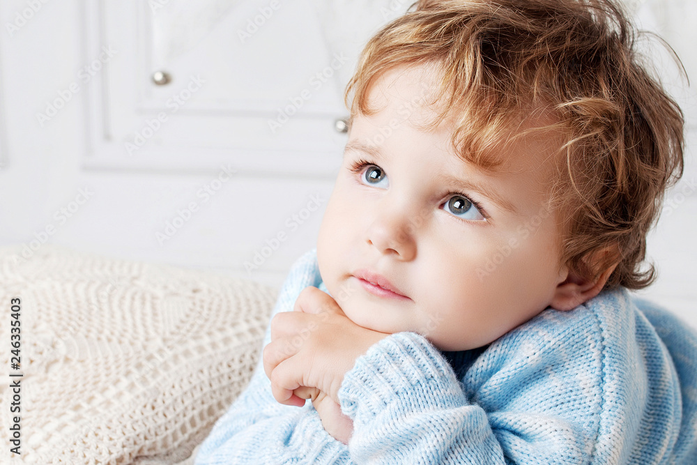 Portrait of happy adorable baby boy on the bed in his room. Copy space Portrait of happy adorable baby boy on the bed in his room. Copy space