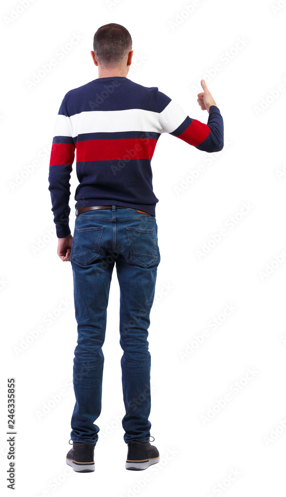Fototapeta premium Back view of man in sweater shows thumbs up.