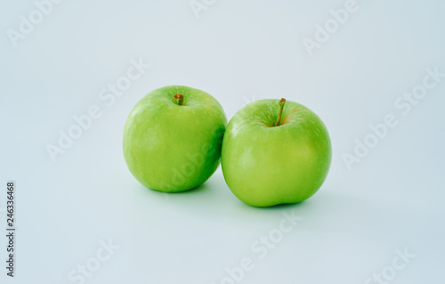 Two green apple on white background .