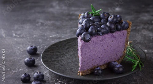 Blueberry vegan cheesecake. Dark photo on black background photo