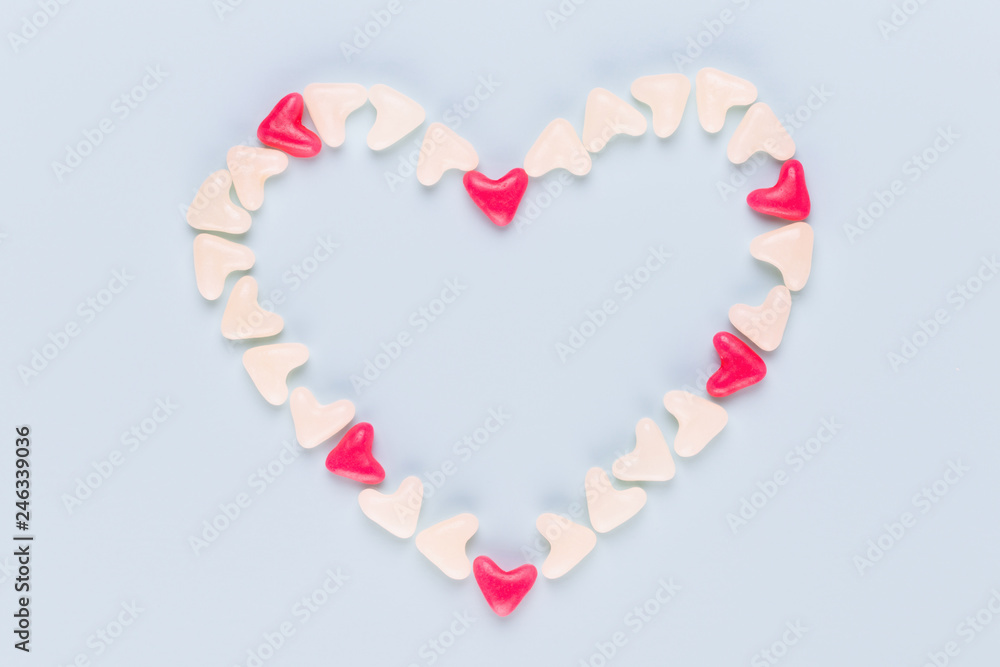 Valentines day background pastel hearts on blue wooden background. Valentines day background pastel hearts on blue wooden background.