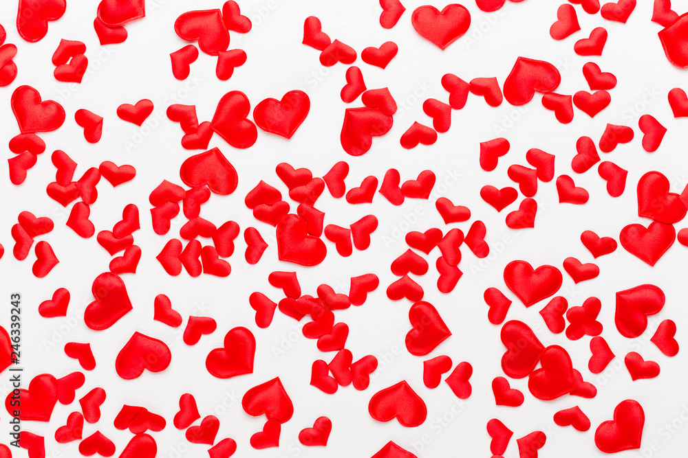 Valentines day background red hearts on white wooden background.