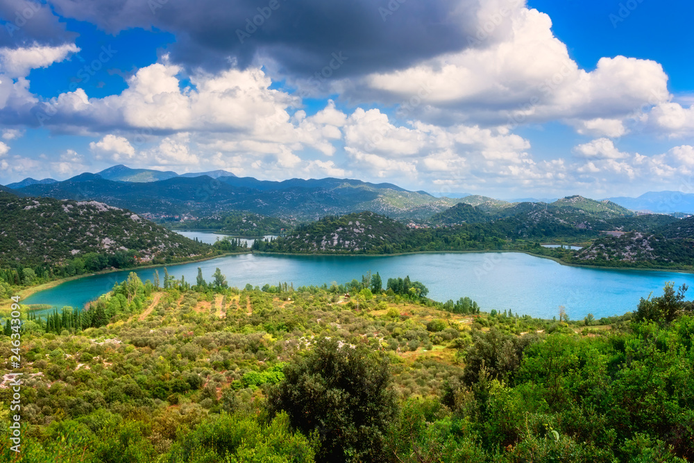 Amazing nature, scenic summer landscape with emerald lakes, mountains and blue cloudy sky, Bacina Lakes (Bacinska jezera), Croatia. Outdoor travel background, view from Adriatic highway