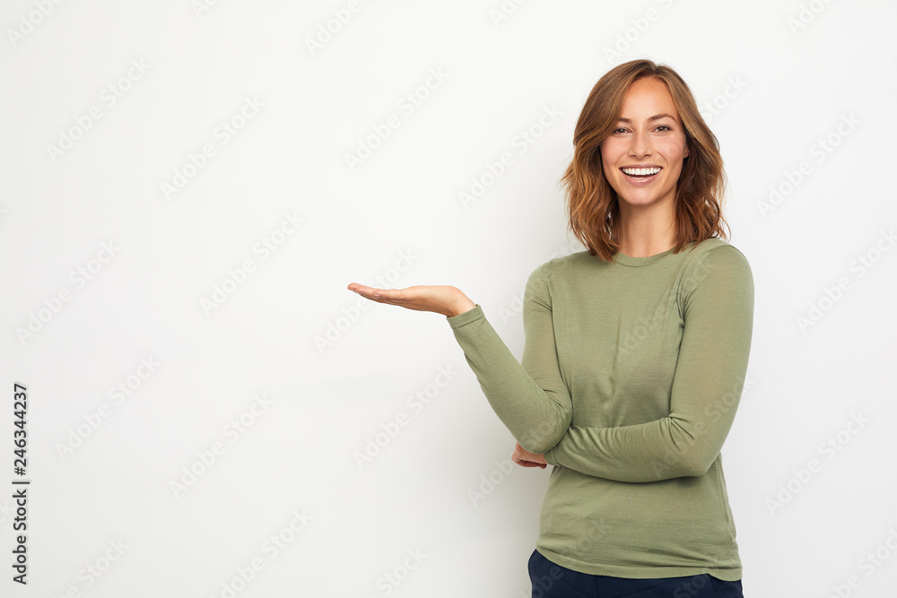 young happy woman presenting your product on the background - obrazy, fototapety, plakaty 