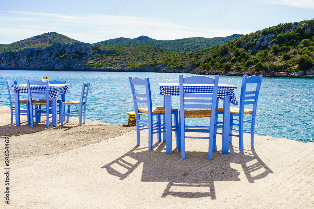 Open cafe outdoor restaurant in Greece on sea shore