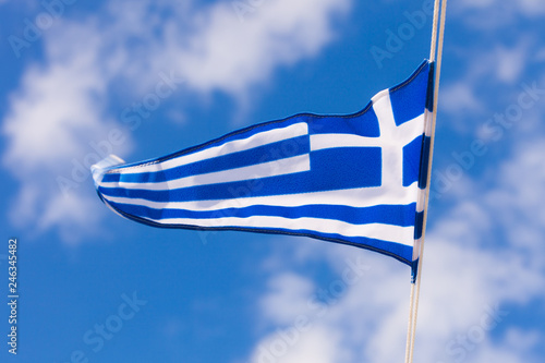 Greek flag waving against blue sky