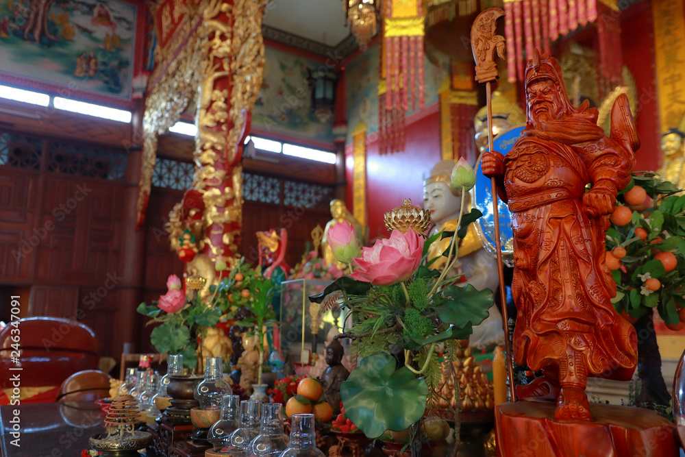 Take photo  wooden sculpture  of  Lost Bladesman as Guan Yu on the altar inside the Chinese buddist building