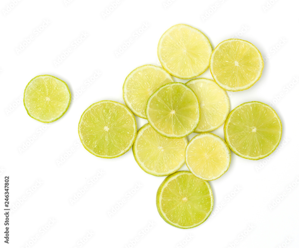 many fresh lime slices lie beautifully arranged on a white background many fresh lime slices lie beautifully arranged on a white background