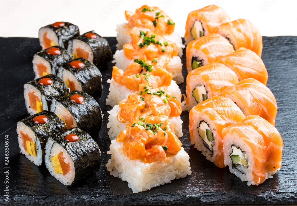 Sushi set on ceramic boards. On white background Sushi set on ceramic boards. On white background